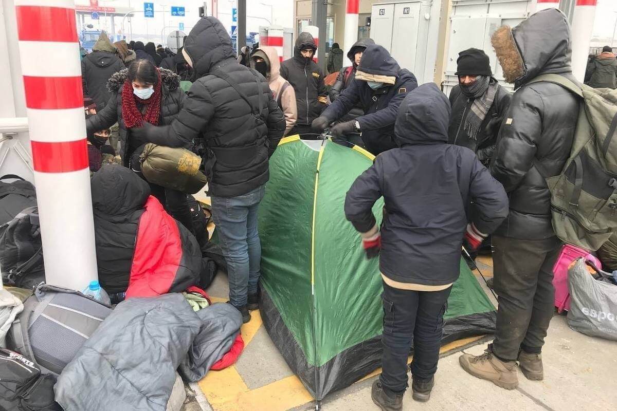 Migrants and Belarusian security forces at the Belarus-Poland border. Monday